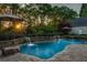 Gorgeous pool featuring integrated waterfalls, stone surround, sun umbrellas, and lush landscaping at 844 Nob Ridge Dr, Marietta, GA 30064