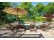 Inviting backyard with a freeform pool, lush landscaping, and patio area with lounge chairs and umbrellas at 844 Nob Ridge Dr, Marietta, GA 30064