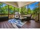 Relaxing screened porch features comfortable seating and a blue patterned rug, perfect for enjoying the outdoors at 844 Nob Ridge Dr, Marietta, GA 30064