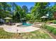 Beautiful backyard with lush landscaping, featuring a large freeform pool, a spa, and stone patio at 844 Nob Ridge Dr, Marietta, GA 30064