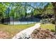 Community tennis court surrounded by lush landscaping and walking path at 844 Nob Ridge Dr, Marietta, GA 30064