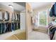Walk-in closet with racks of clothing and a window for natural light at 844 Nob Ridge Dr, Marietta, GA 30064