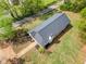 Aerial view features a home with a new roof, manicured landscaping, and a stone pathway, surrounded by green lawns at 1809 Cassville Nw Rd, Cartersville, GA 30121