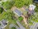 An aerial view of a house with a new roof, surrounded by mature trees and a well-maintained lawn at 1809 Cassville Nw Rd, Cartersville, GA 30121