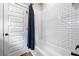 Bathroom featuring white subway tiles in shower and white paneled door at 1809 Cassville Nw Rd, Cartersville, GA 30121