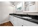 Bathroom featuring double sink vanity with black countertop and modern fixtures at 1809 Cassville Nw Rd, Cartersville, GA 30121