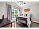 Cozy bedroom with wood floors, and a black paneled crib at 1809 Cassville Nw Rd, Cartersville, GA 30121