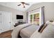 Bright bedroom with wood floors and a mounted television at 1809 Cassville Nw Rd, Cartersville, GA 30121