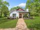 Charming home featuring a manicured lawn and inviting stone pathway to a cozy front porch at 1809 Cassville Nw Rd, Cartersville, GA 30121