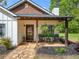 Inviting front porch area with hanging ferns and cozy seating, perfect for relaxing outdoors at 1809 Cassville Nw Rd, Cartersville, GA 30121
