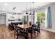 Modern kitchen open to dining area, showcasing stylish pendant lighting and stainless steel appliances at 1809 Cassville Nw Rd, Cartersville, GA 30121