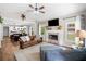 Open-concept living room with fireplace, ceiling fan, and seamless access to dining and kitchen at 1809 Cassville Nw Rd, Cartersville, GA 30121