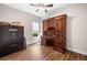 Office with wood floors featuring a large wooden desk and gun safe at 1809 Cassville Nw Rd, Cartersville, GA 30121