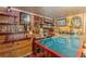 Basement bar boasts rustic charm, featuring wood paneling, a unique skull decor, and a countertop with built-in wine storage at 2733 Winburn Ter, East Point, GA 30344