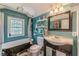 Stylish bathroom with a clawfoot tub, unique tile, and a stained glass window at 2733 Winburn Ter, East Point, GA 30344