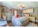 Cozy bedroom with hardwood floors, overhead fan, shelves, and warm decor elements at 2733 Winburn Ter, East Point, GA 30344