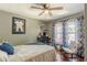 Bright bedroom with hardwood floors, a ceiling fan, and natural light from large windows at 2733 Winburn Ter, East Point, GA 30344