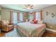 Charming bedroom features a ceiling fan, natural light, hardwood floors, and lovely decor at 2733 Winburn Ter, East Point, GA 30344