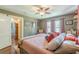 Comfortable bedroom with hardwood floors, ceiling fan, soft rug, and charming details at 2733 Winburn Ter, East Point, GA 30344