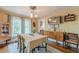Bright dining room with hardwood floors, a vintage cabinet, and ample natural light from large windows at 2733 Winburn Ter, East Point, GA 30344