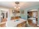 This open dining room offers a seamless flow to the living area, blending comfort and functionality for modern living at 2733 Winburn Ter, East Point, GA 30344