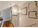 Well-lit hallway with hardwood floors, decorative wall art, and staircase access at 2733 Winburn Ter, East Point, GA 30344
