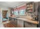 Well-designed kitchen features modern appliances, butcher block countertops, and a functional layout for cooking at 2733 Winburn Ter, East Point, GA 30344