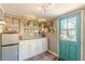 Compact kitchen featuring modern appliances and a vibrant blue door at 2733 Winburn Ter, East Point, GA 30344