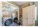 Functional laundry room equipped with modern washer, dryer, and ample storage for efficient household tasks at 2733 Winburn Ter, East Point, GA 30344