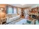 Comfortable living room features a stone fireplace, hardwood floors, and a cream colored sofa at 2733 Winburn Ter, East Point, GA 30344