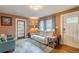 Inviting living room boasts hardwood floors, a comfortable sofa, and ample natural light at 2733 Winburn Ter, East Point, GA 30344