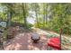 Inviting brick patio with chairs and fire pit, surrounded by lush greenery and quirky decor at 2733 Winburn Ter, East Point, GA 30344