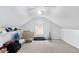 Attic featuring neutral carpet, window, and assorted boxes and containers at 2958 Paul Harris Rd, Dallas, GA 30157