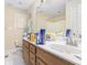 Modest bathroom featuring a white sink, wood cabinet, and white tiled floor at 2958 Paul Harris Rd, Dallas, GA 30157
