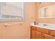 Bathroom with wood vanity, white sink, and window bringing in natural light at 2958 Paul Harris Rd, Dallas, GA 30157