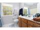 Bathroom with wooden cabinets, white countertop, and window with natural light at 2958 Paul Harris Rd, Dallas, GA 30157