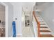 Bright foyer featuring tile flooring, staircase with white risers and wooden handrail at 2958 Paul Harris Rd, Dallas, GA 30157