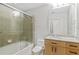 Bathroom featuring tiled shower with glass door, wooden vanity and granite countertop at 361 17Th Nw St # 1708, Atlanta, GA 30363