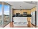 Condo kitchen with stainless appliances, wood cabinets, black backsplash and a counter overlooking the city at 361 17Th Nw St # 1708, Atlanta, GA 30363