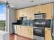 Modern kitchen featuring stainless steel appliances, sleek black backsplash and light wood cabinets at 361 17Th Nw St # 1708, Atlanta, GA 30363
