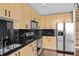 Bright kitchen featuring black backsplash, stainless steel appliances, and light-colored wooden cabinets at 361 17Th Nw St # 1708, Atlanta, GA 30363