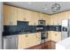 Well-lit kitchen boasts stainless steel appliances, black backsplash and light wood cabinetry at 361 17Th Nw St # 1708, Atlanta, GA 30363