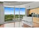 Living area next to the kitchen with city view through a large window and access to a balcony at 361 17Th Nw St # 1708, Atlanta, GA 30363