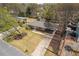Aerial view of a single-story home with a carport, a well-kept lawn, and mature trees at 43 Lott Se Ave, Marietta, GA 30067