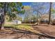 Beautiful backyard featuring lush lawn, storage shed, playset, mature trees, and wooden fence at 43 Lott Se Ave, Marietta, GA 30067