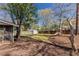 Large backyard with mature trees, green grass, storage shed and play set at 43 Lott Se Ave, Marietta, GA 30067