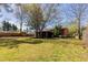 Lush backyard with a privacy fence and a view of the home's exterior, including a screened porch at 43 Lott Se Ave, Marietta, GA 30067