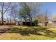 Spacious backyard with a grassy lawn, mature trees, and a wood fence at 43 Lott Se Ave, Marietta, GA 30067