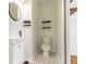 Cozy bathroom with modern toilet, vanity, mirror and eye-catching patterned tile floors at 43 Lott Se Ave, Marietta, GA 30067