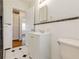 Bathroom with black and white tile flooring, modern white vanity, and plenty of natural light at 43 Lott Se Ave, Marietta, GA 30067